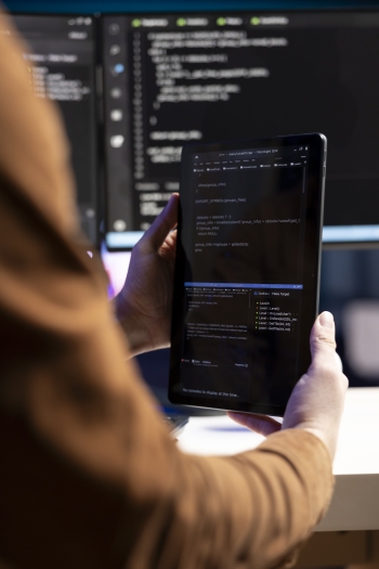 Teleworking programmer designing and developing software using tablet